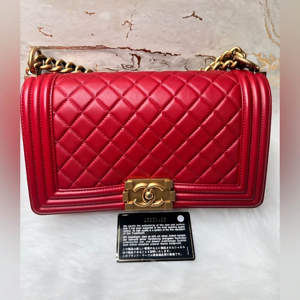 Authentic  CHANEL Red Quilted Boy  Bag with Gold Hardware.